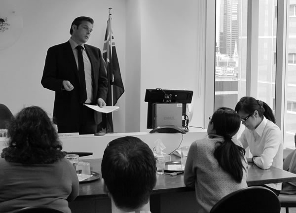Member Mr Charlie Powles presides over a staged hearing at the Melbourne RRT information session during 2012 Refugee Week.